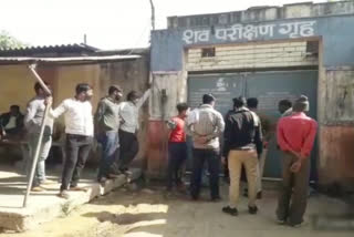 People standing outside the corpse