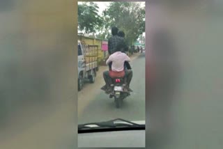 four persons ride in single bike