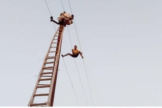 young-man-climb-on-High-voltage-electricity-tower