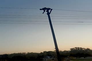 young-man-climb-on-high-voltage-electricity-tower