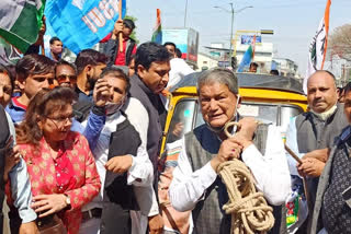 Harish Rawat pulls auto-rickshaw with rope to protest fuel prices Harish Rawat pulls auto-rickshaw with rope to protest fuel prices