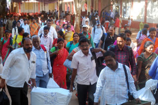 Election staff carrying ballot boxes