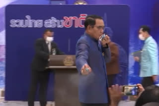 Thai prime minister sprays alcohol on reporters