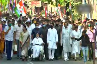 Mamata Banerjee holds a roadshow on a wheelchair