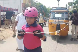 Six year old girl pulls auto by wearing skate roller urging 100 percent voting