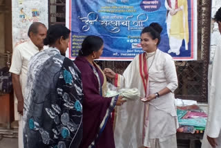 Distribution of clothes made to poor women