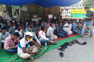 forest workers sitting in protest against outsourcing