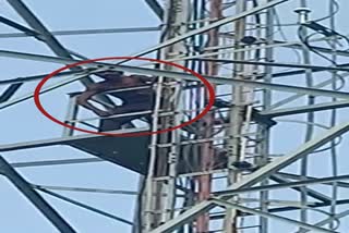 young man climbed on mobile tower