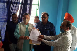 memorandum to MLA Pushkar Singh Dhami