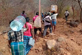 Officers carrying voting machines on their heads in Rasipuram hill villages