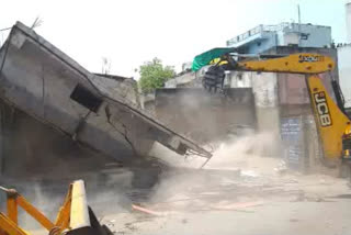 Bulldozer on illegal colony