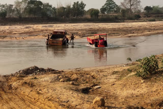 Illegal sand mining by river