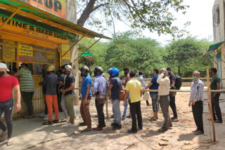 Long queues at liquor shops after lockdown was announced in Delhi