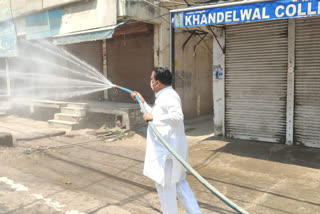 corporation councilor sanjay thakur sanitizes ignou road shops