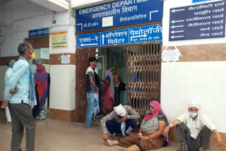 patient sitting at the district hospital gate