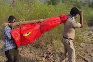 Cop carries dead body