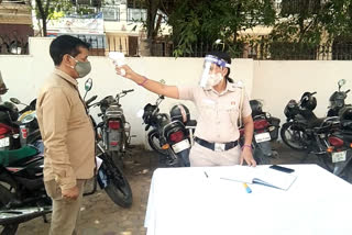 sanitization and temperature check in dabri police station