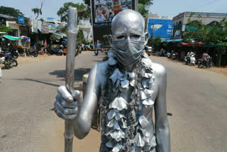 a man begging in mahatma gandhi dressing