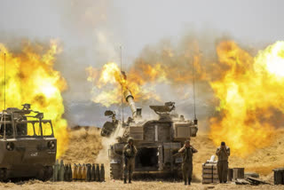 An Israeli artillery unit fires toward targets in Gaza Strip, at the Israeli Gaza border