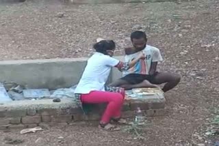 nurse feeds the handicapped person outside covid testing center