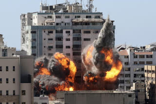 The building housing the offices of The Associated Press and other media in Gaza City collapses after it was hit by an Israeli airstrike