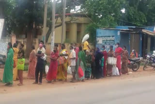 people gathering in front of ration shops