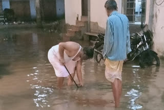 People draining water from homes