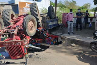 Overloaded tractor trolley, trolley overturned