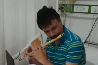 corona ward patient playing flute