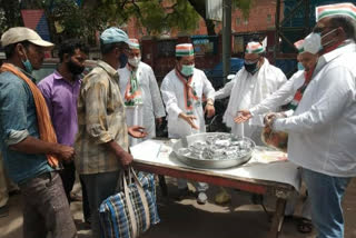 Congress workers distribute food to needy people outside LNJP Hospital in Delhi