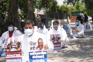NSUI workers wearing PPE kit protest demand cancellation 12th board exam