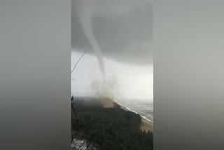 waterspout funnel shaped cloud on sea in karwar