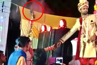 Bride fires gun in the air before walking on stage