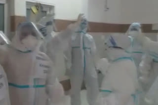 PPE clad women health workers dance to relieve stress