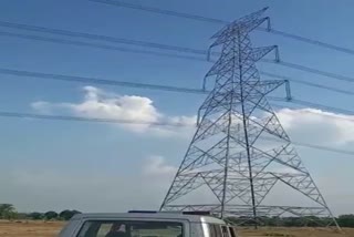 man climbed on electric tower