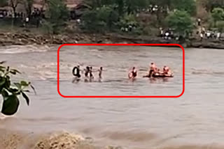 4 children trapped on a rock in a raging river