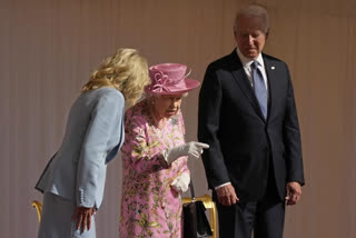 Britain's Queen Elizabeth II speaks to US First Lady Jill Biden, left, while US President Joe Bidenlooks on