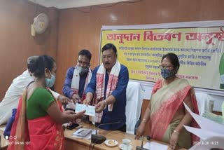 Minister of Disaster management Jogen Mohan giving compensation At Dibrugarh