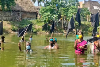 உழவர்கள் போராட்டம்  காவிரி ஆறு  black flag  Farmers protest by standing in the river with the black flag  mayiladuthurai news  mayiladuthurai latest news  mayiladuthurai farmer protest  mayiladuthurai Farmers protest in the river with the black flag  farmer protest  மயிலாடுதுறையில் விவசாயிகள் போராட்டம்  கருப்புக் கொடி  கருப்புக் கொடி ஏந்தி விவசாயிகள் போராட்டம்  மயிலாடுதுறையில் விவசாயிகள் போராட்டம்  ஆற்றில் இறங்கி விவசாயிகள் போராட்டம்  கருப்பு கொடியுடன் ஆற்றில் இறங்கி விவசாயிகள் போராட்டம்  மயிலாடுதுறை கருப்பு கொடியுடன் ஆற்றில் இறங்கி விவசாயிகள் போராட்டம்  மயிலாடுதுறை செய்திகள்