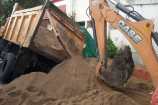 father son buried under sand