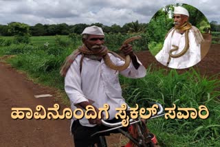 mans cycle ride with snake at belagavi