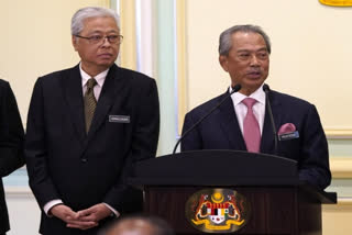 Malaysia's Prime Minister Muhyiddin Yassin, right, and Defense Minister Ismail Sabri Yaakob