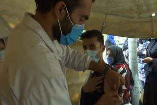 Afghans receive COVID-19 jabs after donation by US