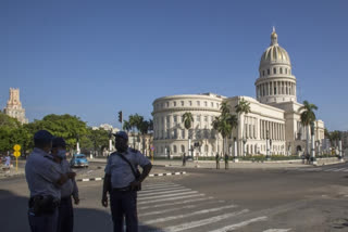 Police stand guard near the National Capitol building in Havana, Cuba