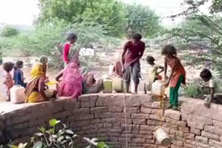 Tribals filling water from cemetery well