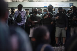 Commuters wait for a public Rapid Transit Bus (BRT) during the COVID-19 pandemic in Rio de Janeiro, Brazil, Friday, July 23, 2021, during the COVID-19 pandemic. (AP Photo/Bruna Prado)