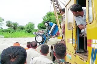 Two youths drowned in water with tractor while crossing road