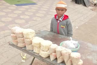 A 10-yr-old boy sells bird food in Hyderabad