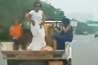 Woman dances in a moving open vehicle_vis_up_noida_upur10010