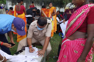 IC fill up government scheme forms for women in Duare Sarkar camp at English Bazar